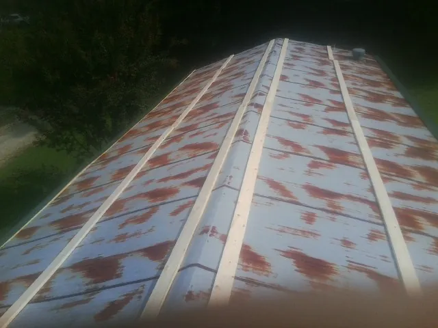 Rusted metal roof panels with new wood purlins before replacement — Storm Damage Roof Repair in Elk by Roofing Brothers